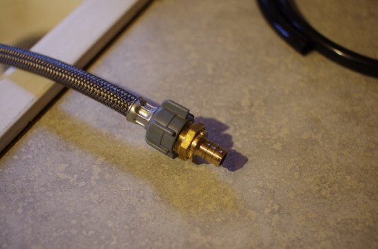 the end of the metal tubing that connects to the water hose