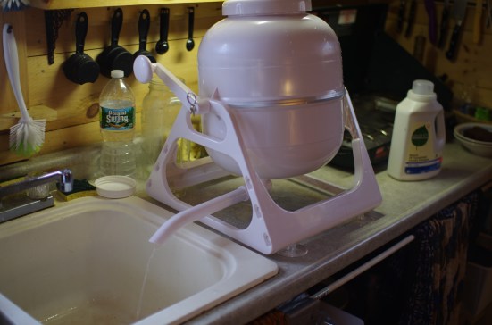 Draining the water into the sink, which in turn drains into a 5 gallon bucket under the sink which we then dump in the woods.